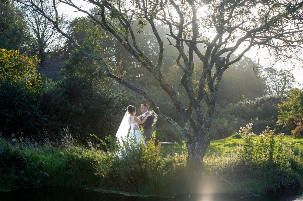 Bride and groom at golden hour by the water at Calloose