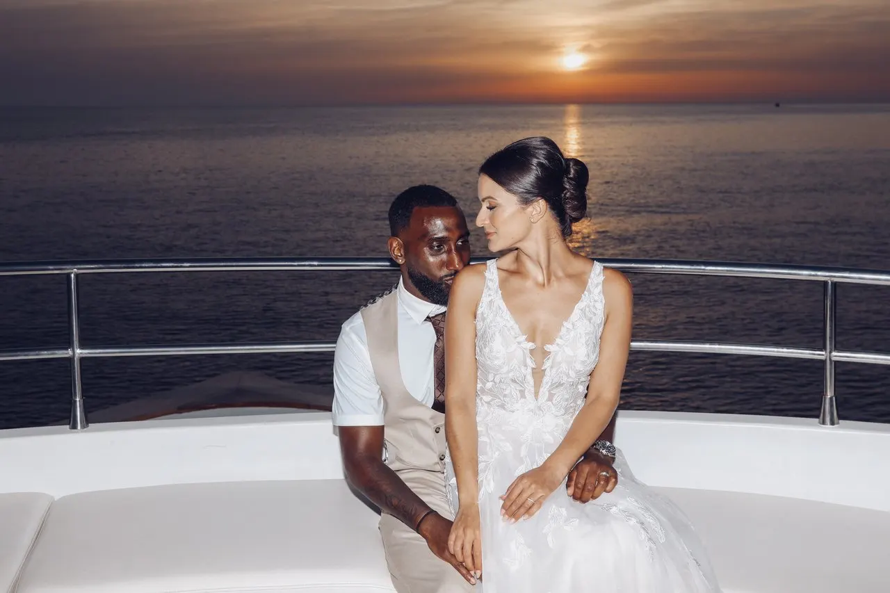 Bride and groom on a yacht at sunset