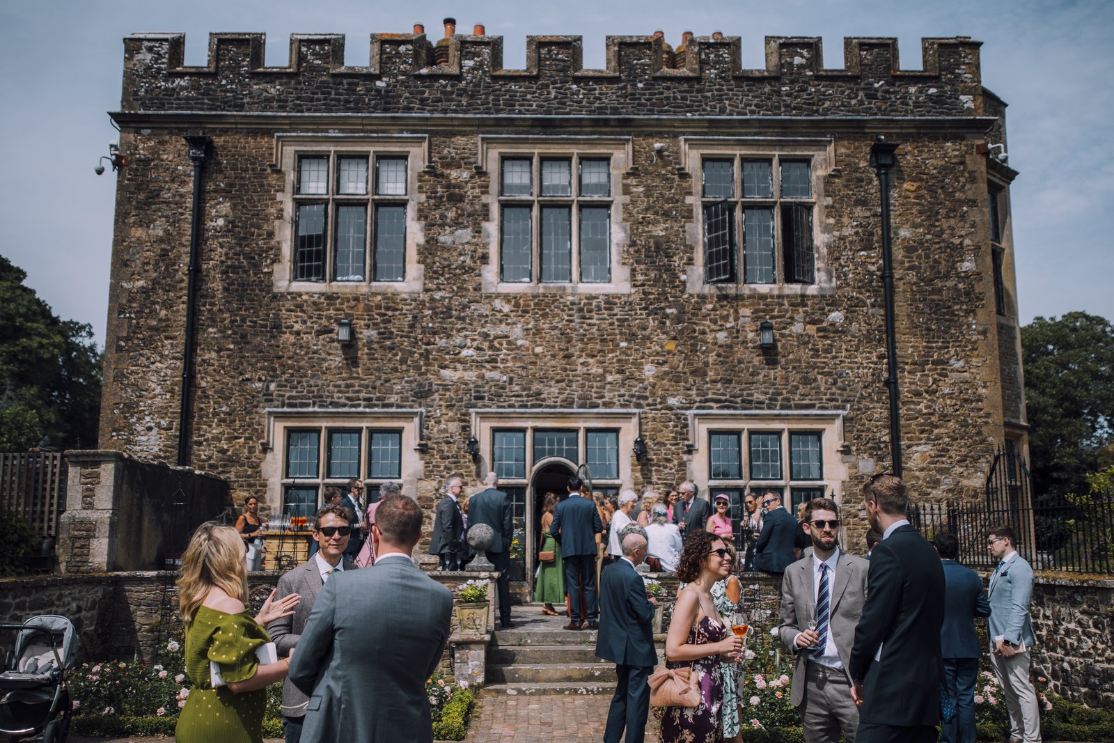 Wedding guests outside Greyfriars, a castellated Gothic manor house